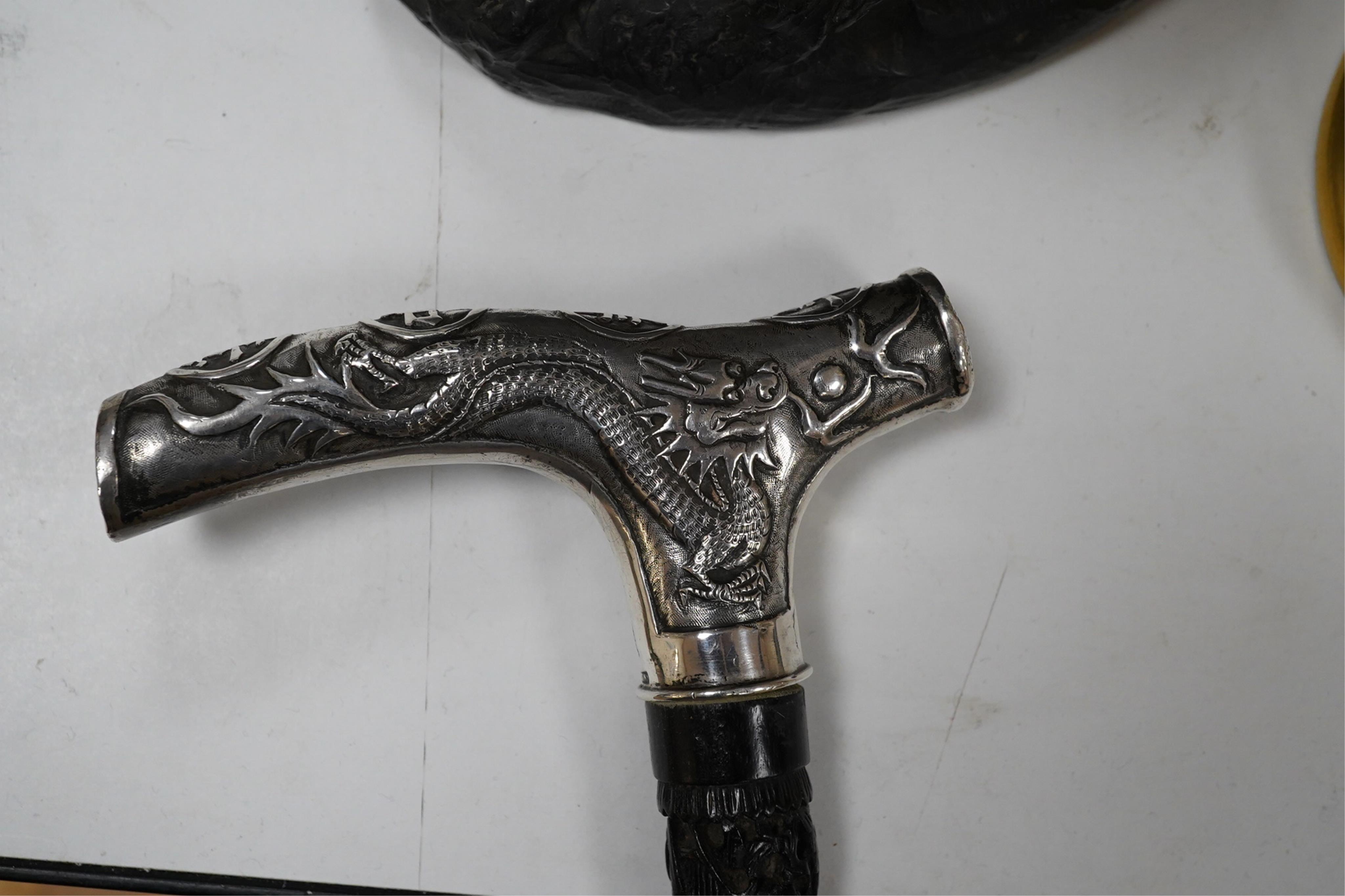 A 19th century Chinese export silver ‘dragon’ handled carved ebony walking cane, handle signed, 81cm long. Condition - fair to good